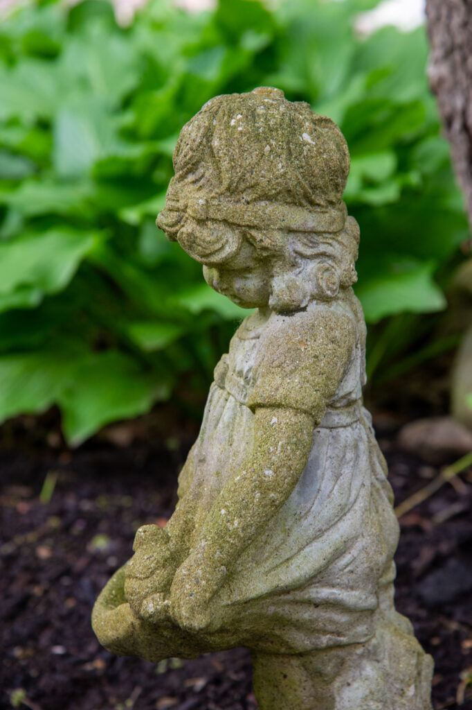 girl statue with hosta