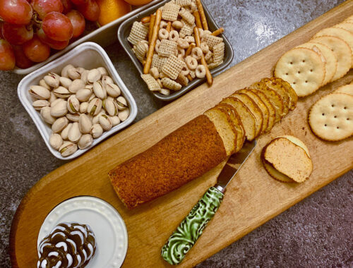 cheese roll on board with crackers