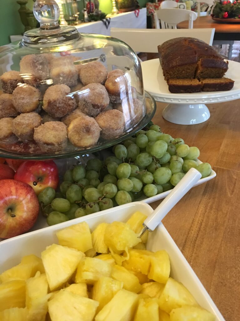 french muffins in cake stand with fruit on tray below