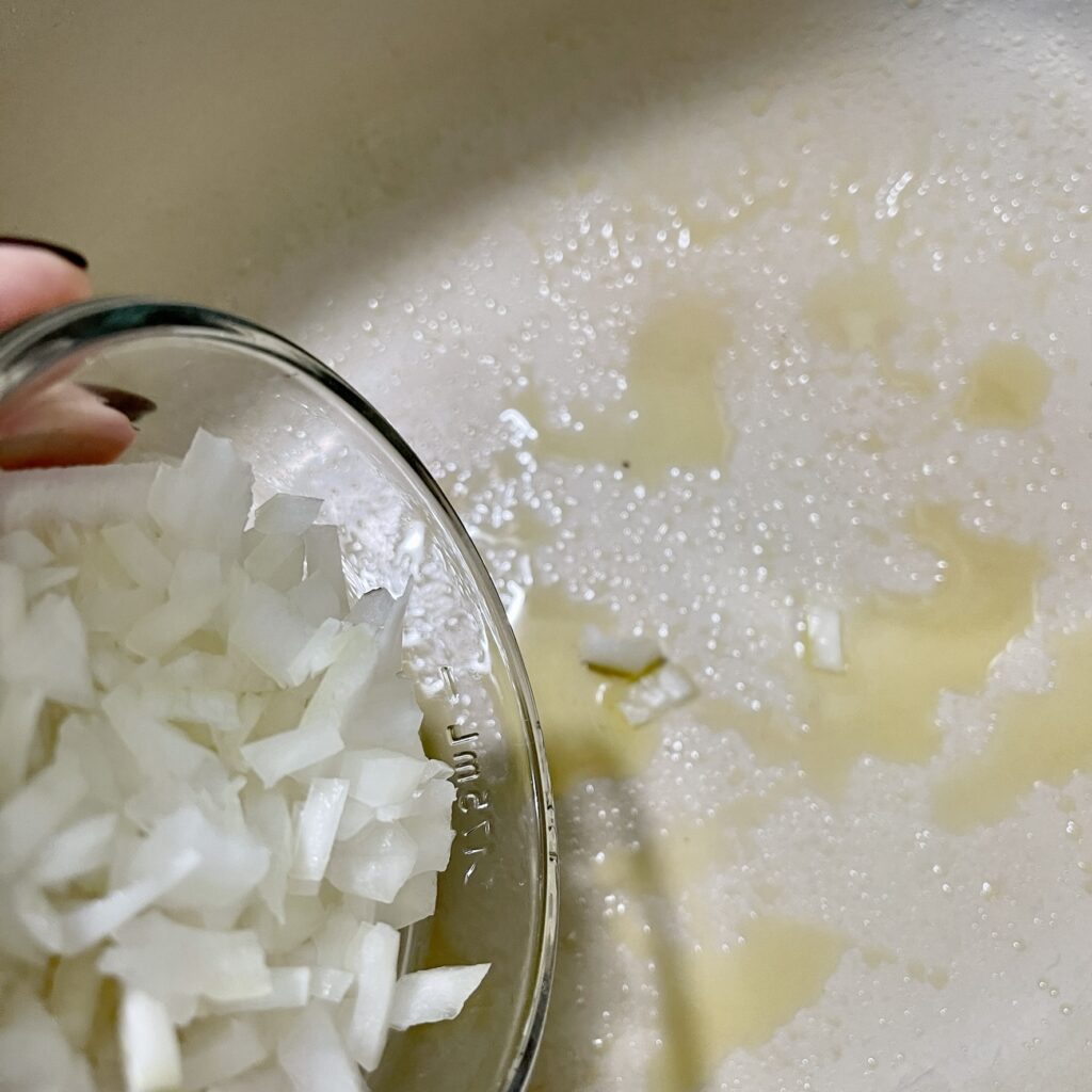 Saute minced onion in olive oil in a Dutch Oven