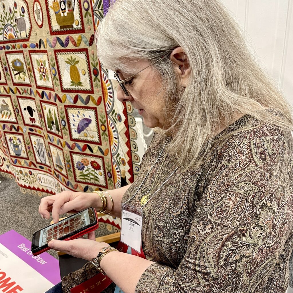 Janet Stone talking to the crowd about her methods in making her BEST in SHOW beautiful quilt.