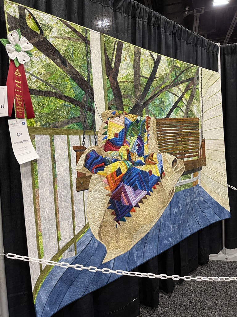 AQS Winner 2nd Wall Quilt with Quilt on Garden Swing