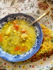 bowl of soup and fresh farm veggie frittata on a plate
