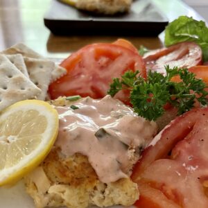 salmon patties with tomato and lemon and saltines