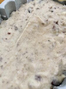 Banana bread batter added to loaf pan