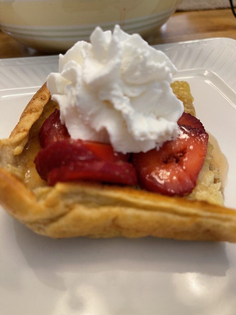 Dutch Baby pancake with strawberries and whipped cream