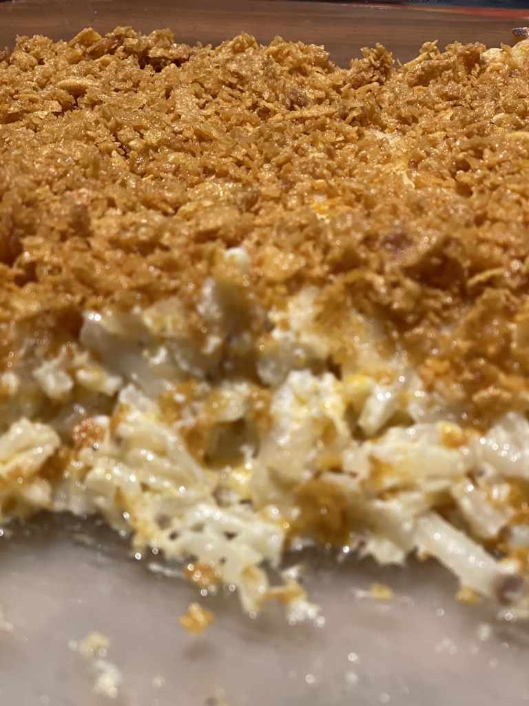 close up of serving dish of hash brown potato casserole