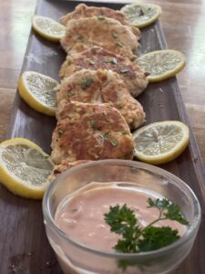 tray with salmon patties, lemon slices and thousand island dressing