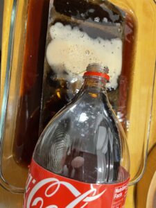adding coca cola on cast iron to remove rust