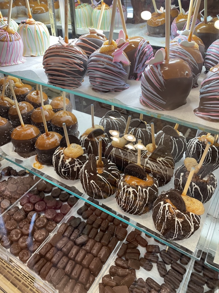 Candy shop display of chocolates and dipped apples