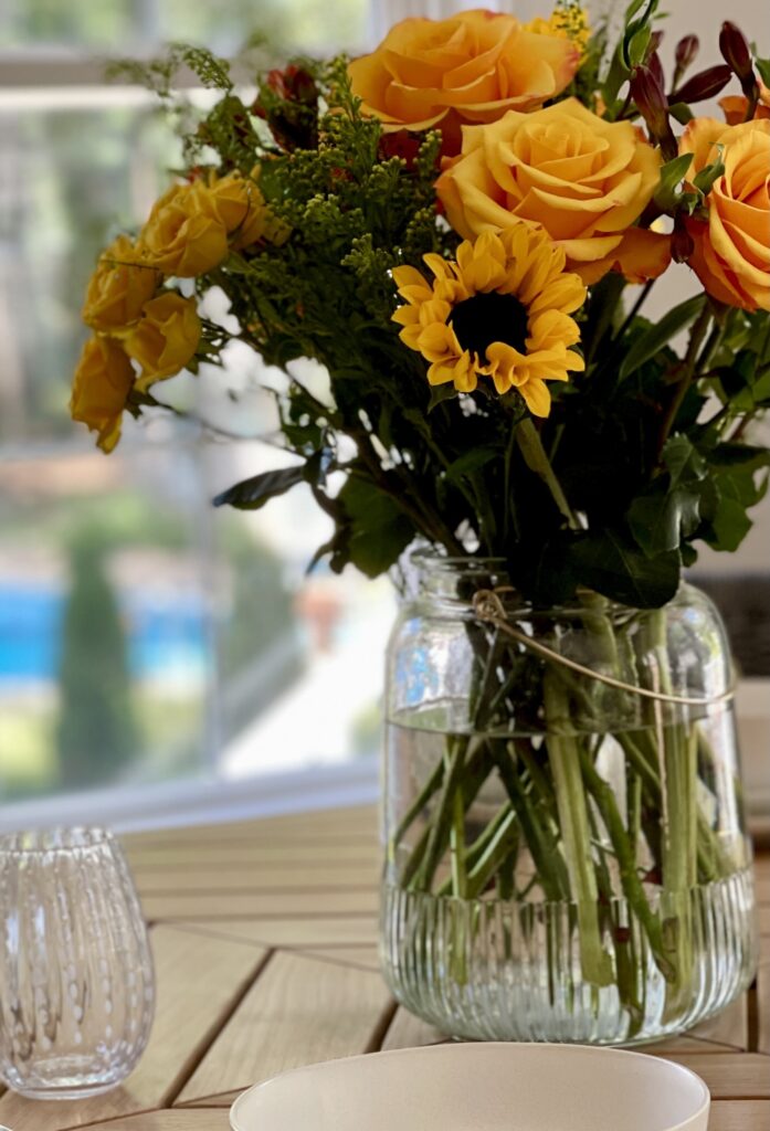 vase of sunflowers on breakfast table