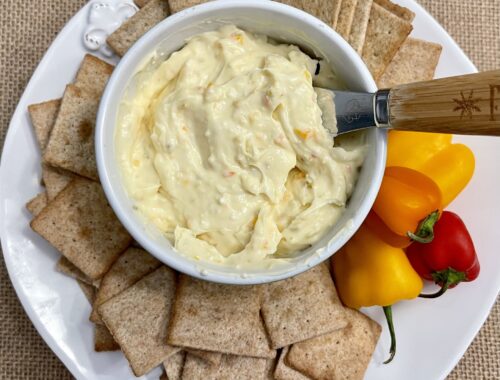 pepper jelly dip with crackers and peppers