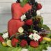 watermelon cake decorated with fruit, roses and rosemary