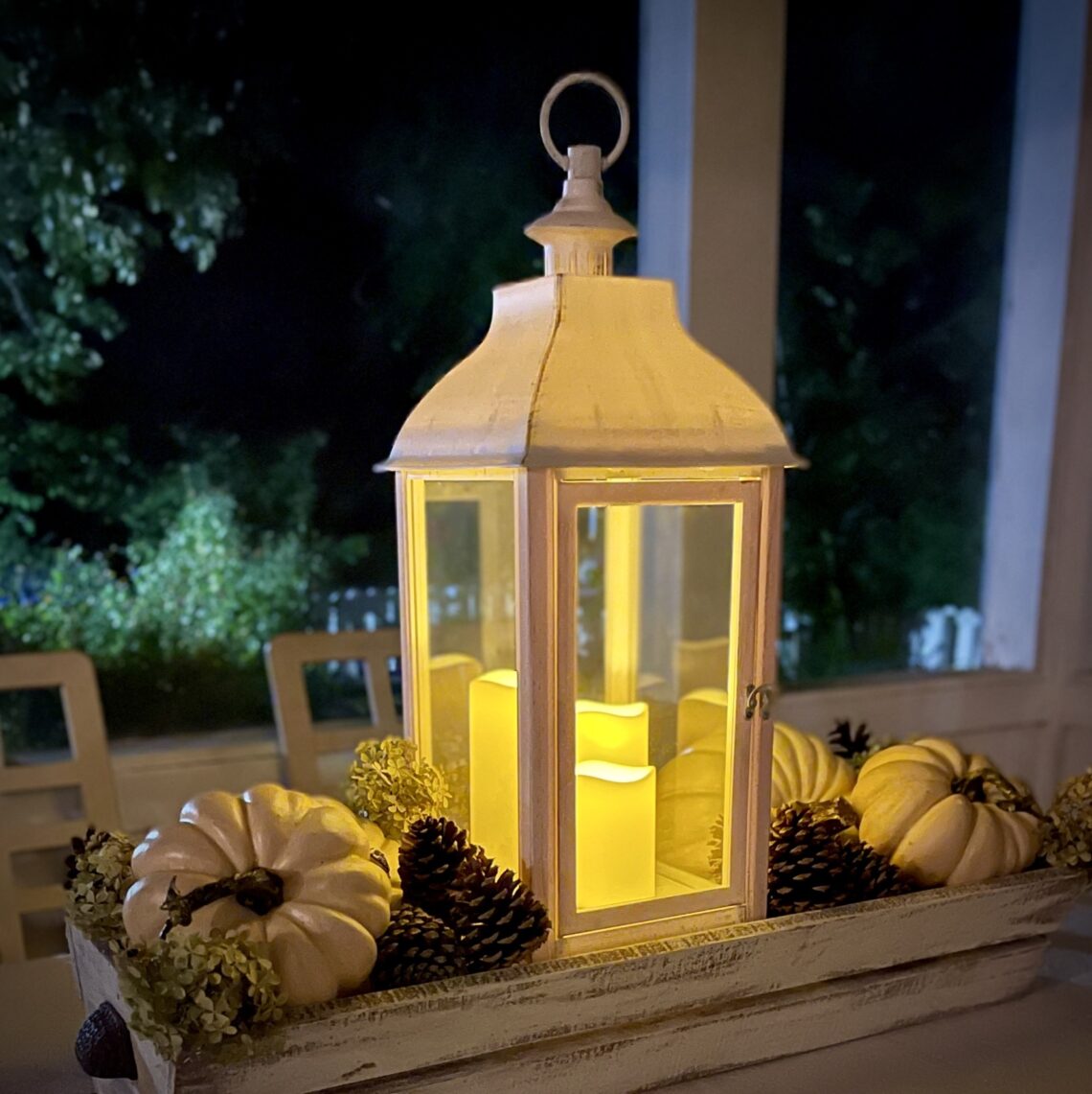 Lantern with pumpkins in trough