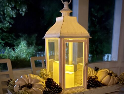 Lantern with pumpkins in trough