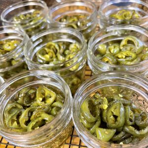 cooked jalapenos added to canning jars