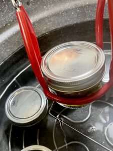 adding jars to water bath canner