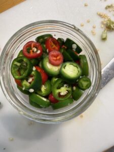 sliced jalapenos in a jar