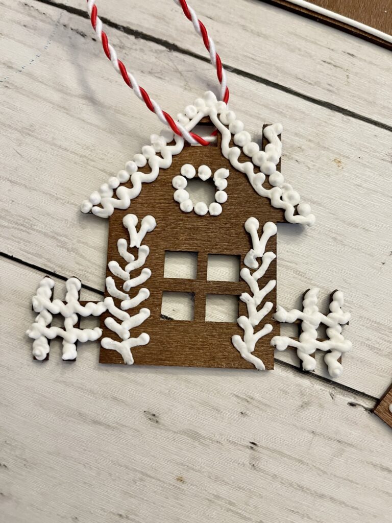 single wooden gingerbread house with picket fence