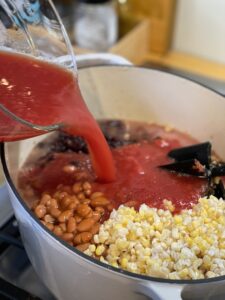 Adding ingredients to taco soup