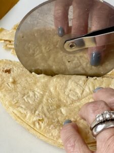 cut corn tortillas to make tortilla strips for taco soup