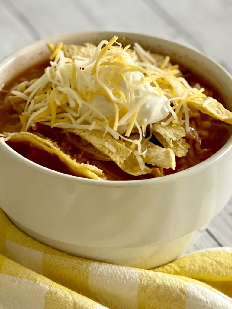Taco soup recipe in bowl with toppings