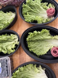 lettuce leave added as base to charcuterie boxes