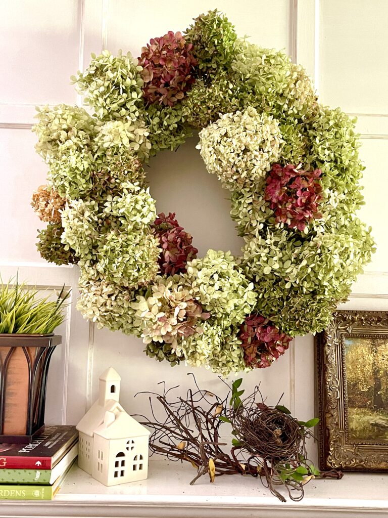 fall hydrangea wreath hung on mantel