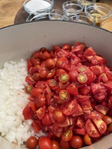 tomatoes and onions for tomato jam in pot