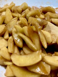 fried apples with wooden spoon