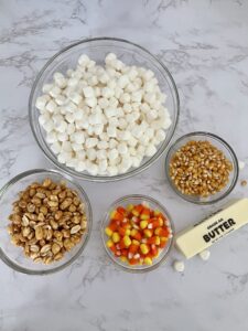 Uncooked ingredients for candy corn popcorn balls