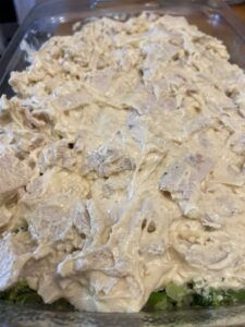 chicken mixture added to casserole dish for chicken divan recipe
