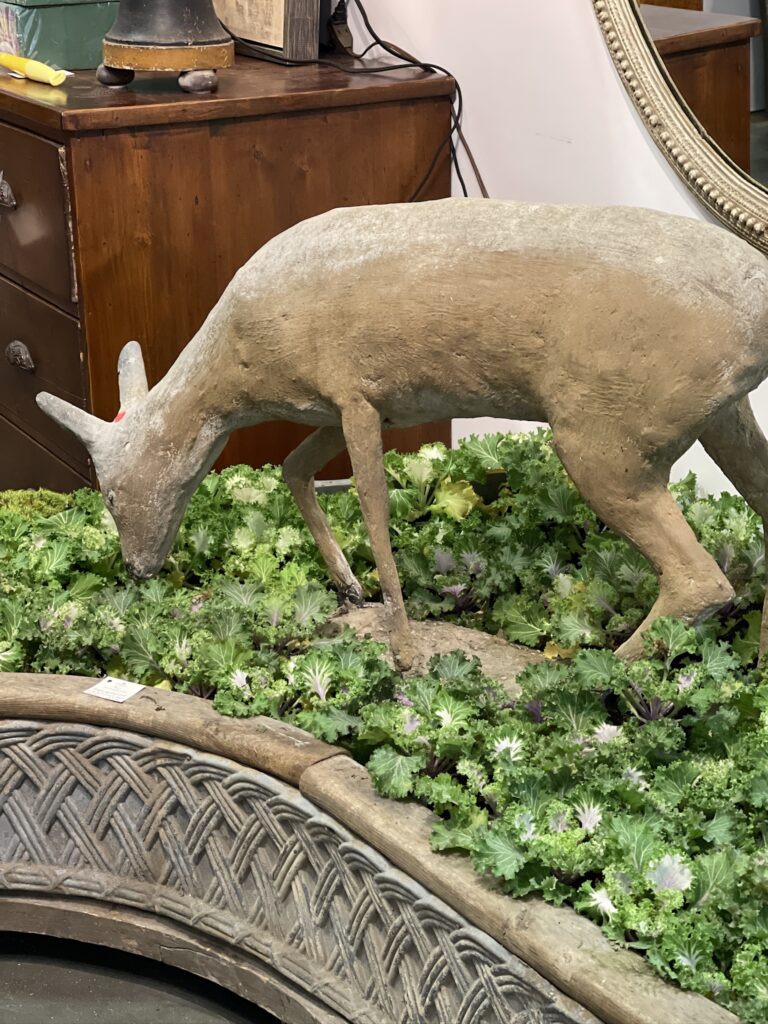 deer grazing in concrete planter at Nashville Antiques and Garden show 2024