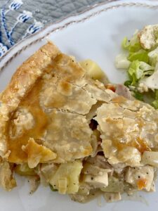 Slice of chicken pot pie with salad
