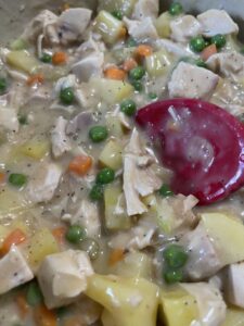 add vegetables to thickened sauce for chicken pot pie filling