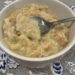 gluten free chicken and dumplings in a bowl with a spoon