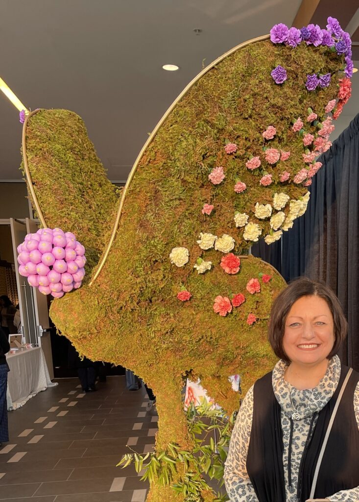 me with moss butterfly at the Nashville Antiques and Garden show entrance