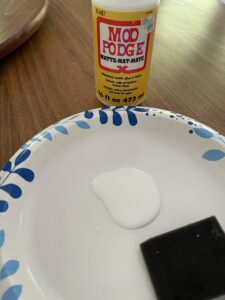 Mod Podge added to paper plate for easy clean up of DIY project