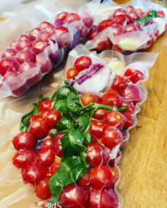 Freezer bags filled with tomatoes, garlic, onion and basil for tomato sauce packets