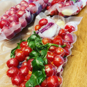 Freezer bags filled with tomatoes, garlic, onion and basil for tomato sauce packets