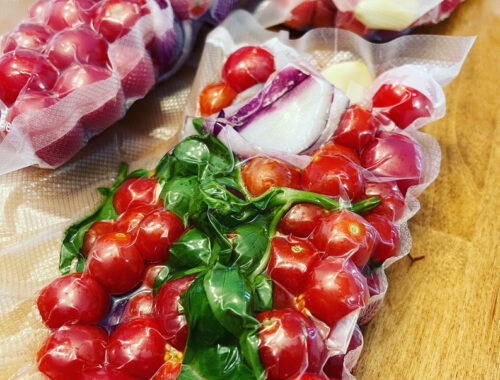 Freezer bags filled with tomatoes, garlic, onion and basil for tomato sauce packets