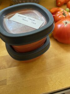 Roasted tomato sauce added to freezer containers