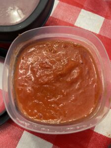 filled freezer container of roasted tomato sauce