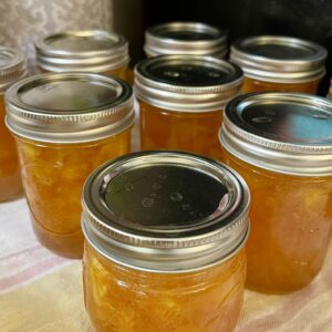 canned half pint jars of homemade peach jam