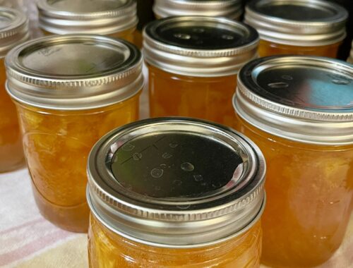 canned half pint jars of homemade peach jam