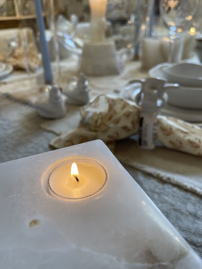 Iron Gate table setting with lit candle