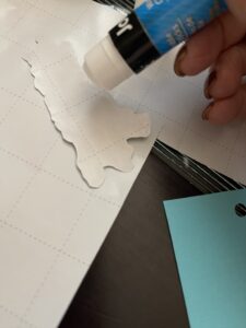 cutting out wrapping paper image of dog for DIY gift tags