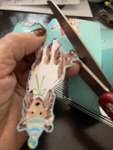 cutting out wrapping paper image of dog for DIY gift tags