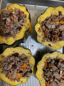 adding stuffing to roasted acorn squash