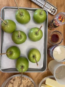 Skewers added to apples for caramel apple recipe